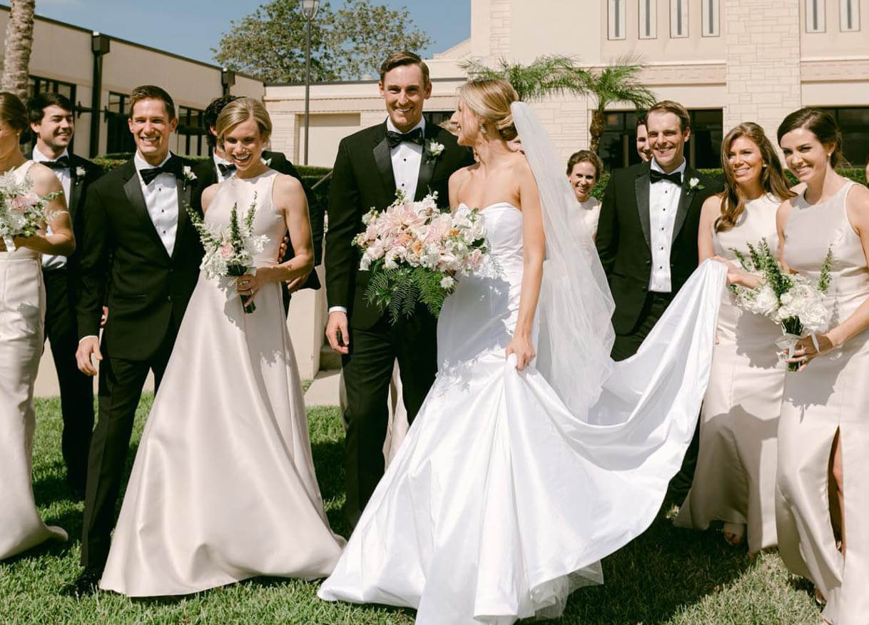 Сouples wearing a white gowns and a black suits