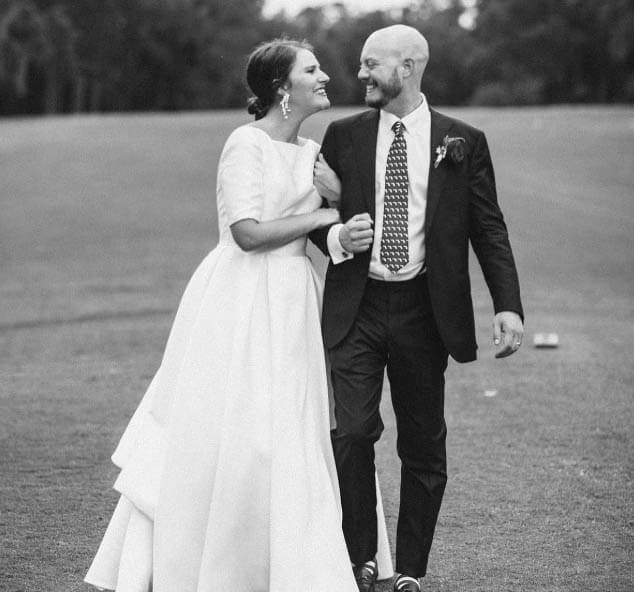 Сouple wearing a white gown and a black suit