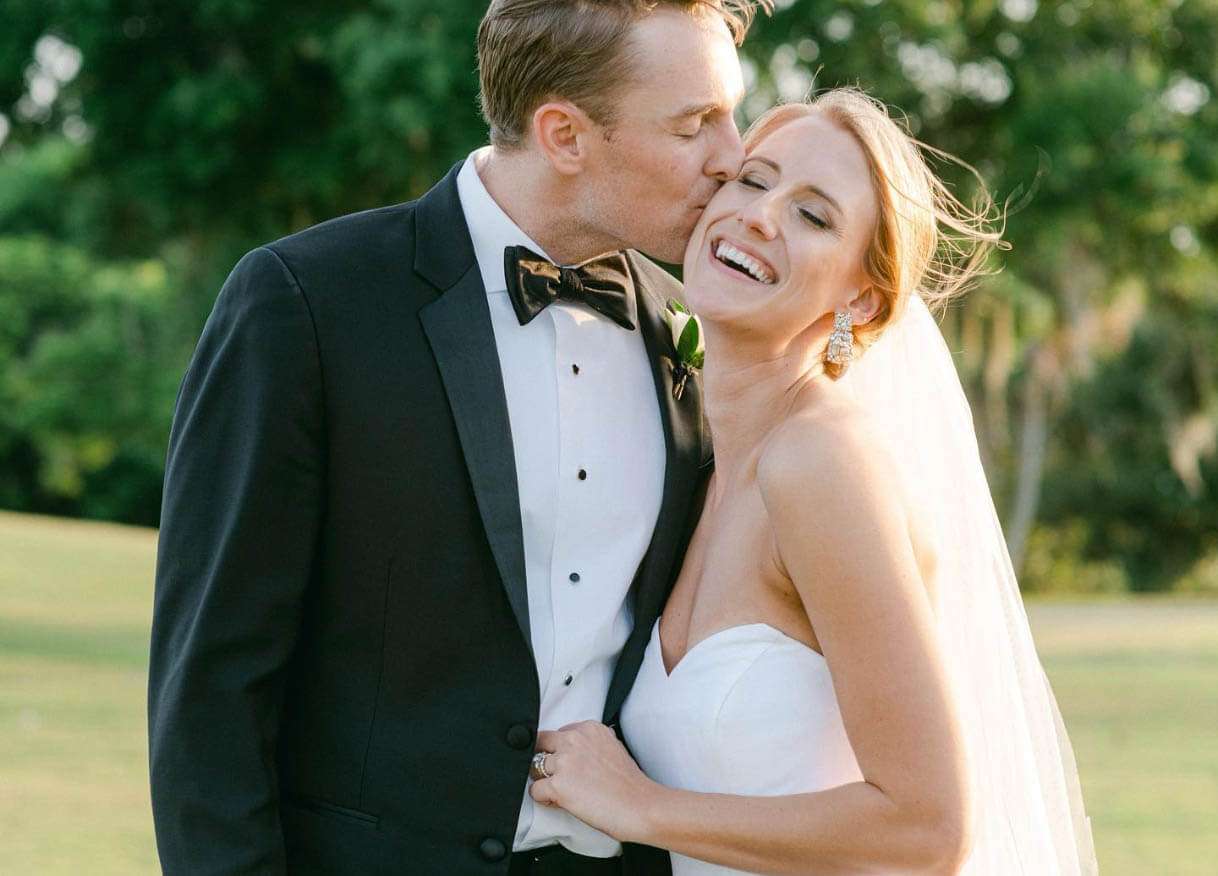 Сouple wearing a white gown and a black suit