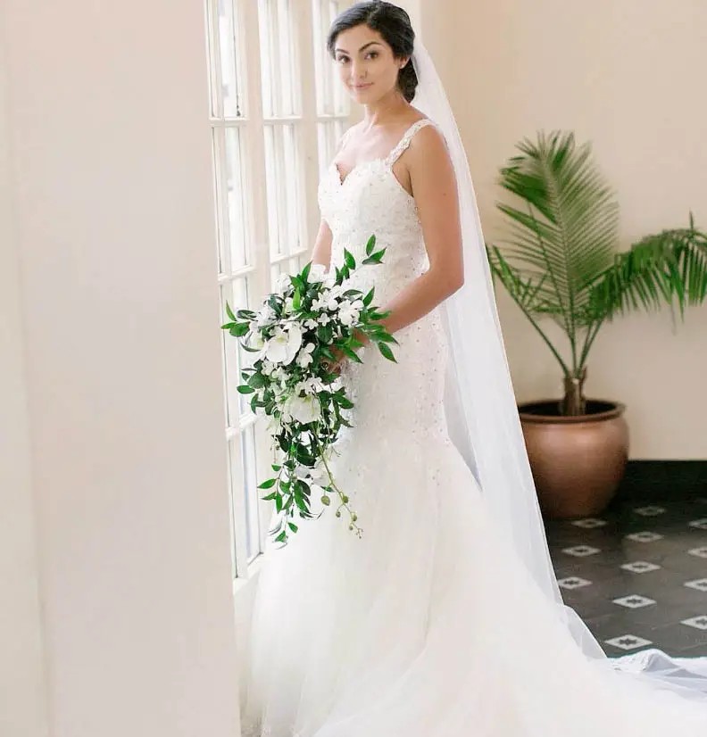 Сouple wearing a white gown and a black suit